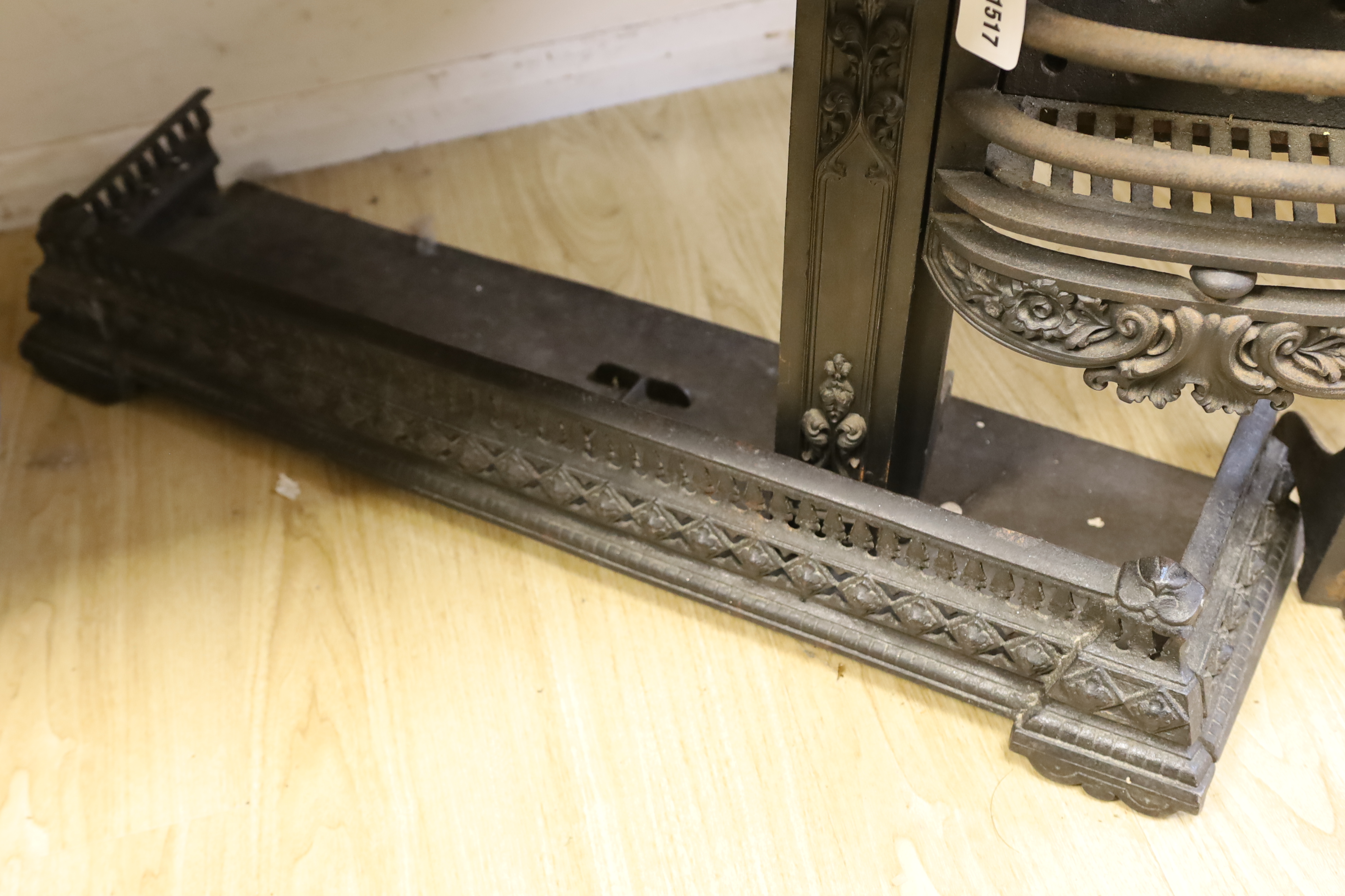 A cast iron and fire grate and fender, fire grate 52cm high